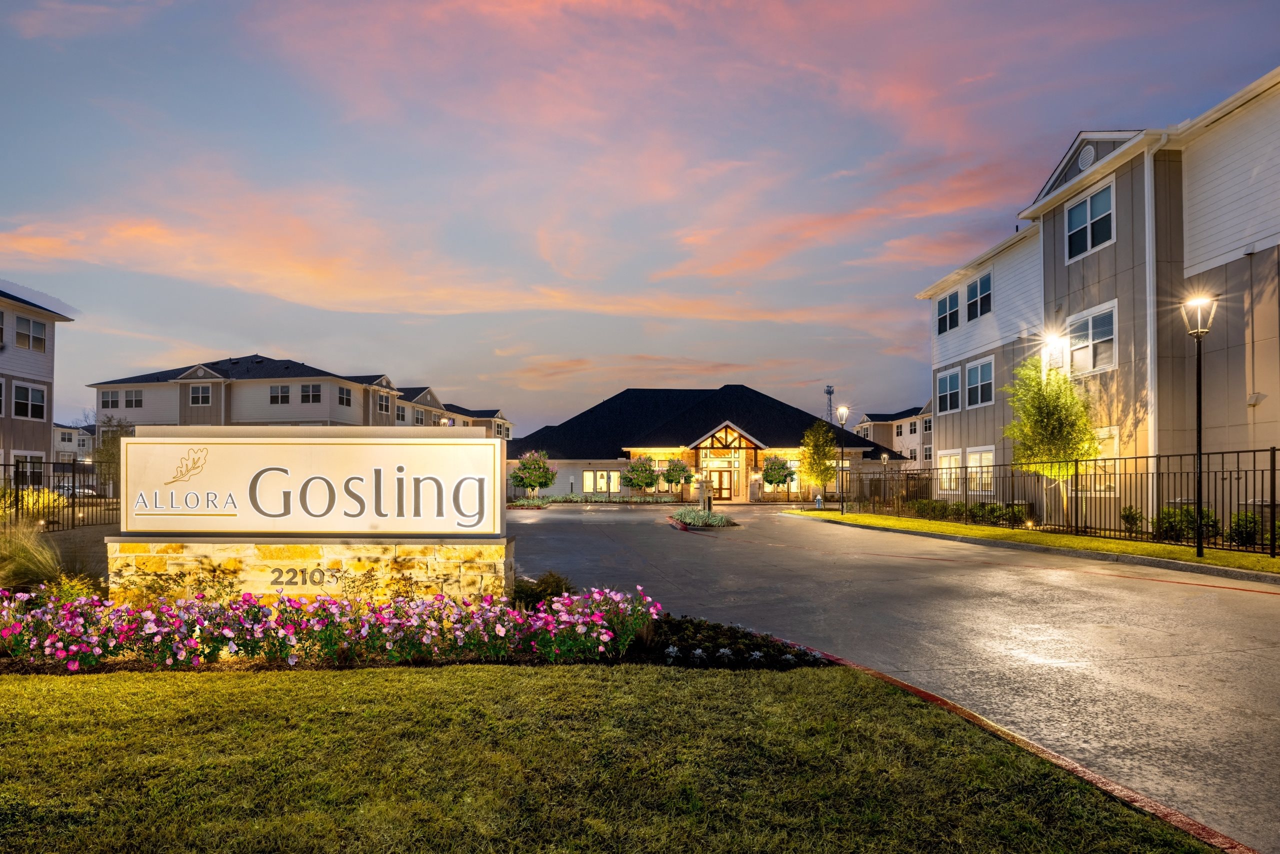 a building with a sign that reads gossing on the side of a road